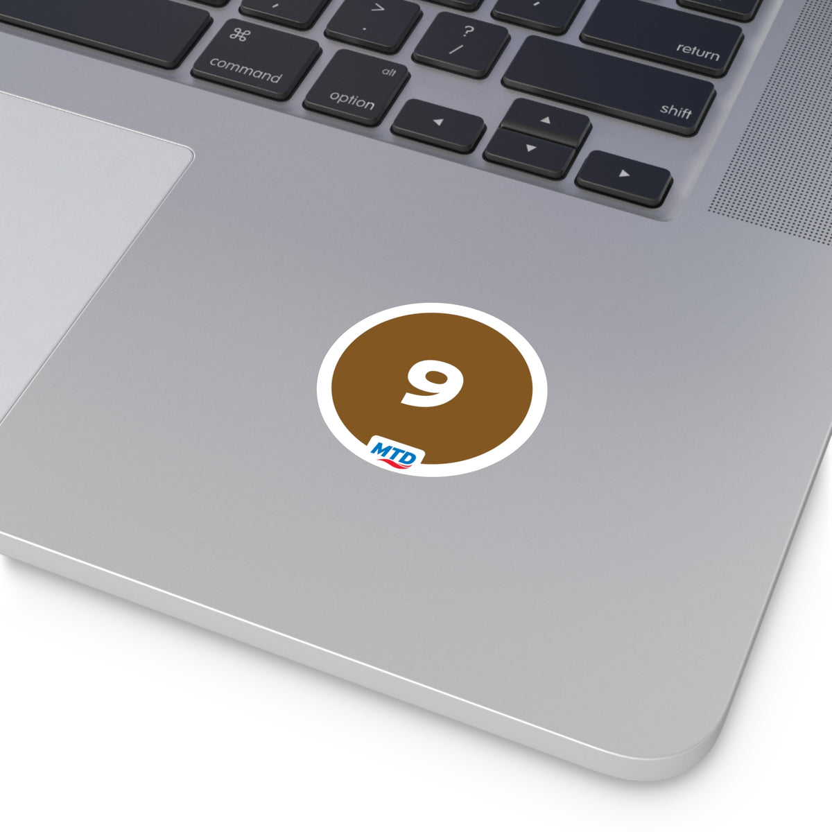 Circular vinyl sticker featuring the MTD Route 9 bubble in brown with a bold route number and MTD logo.