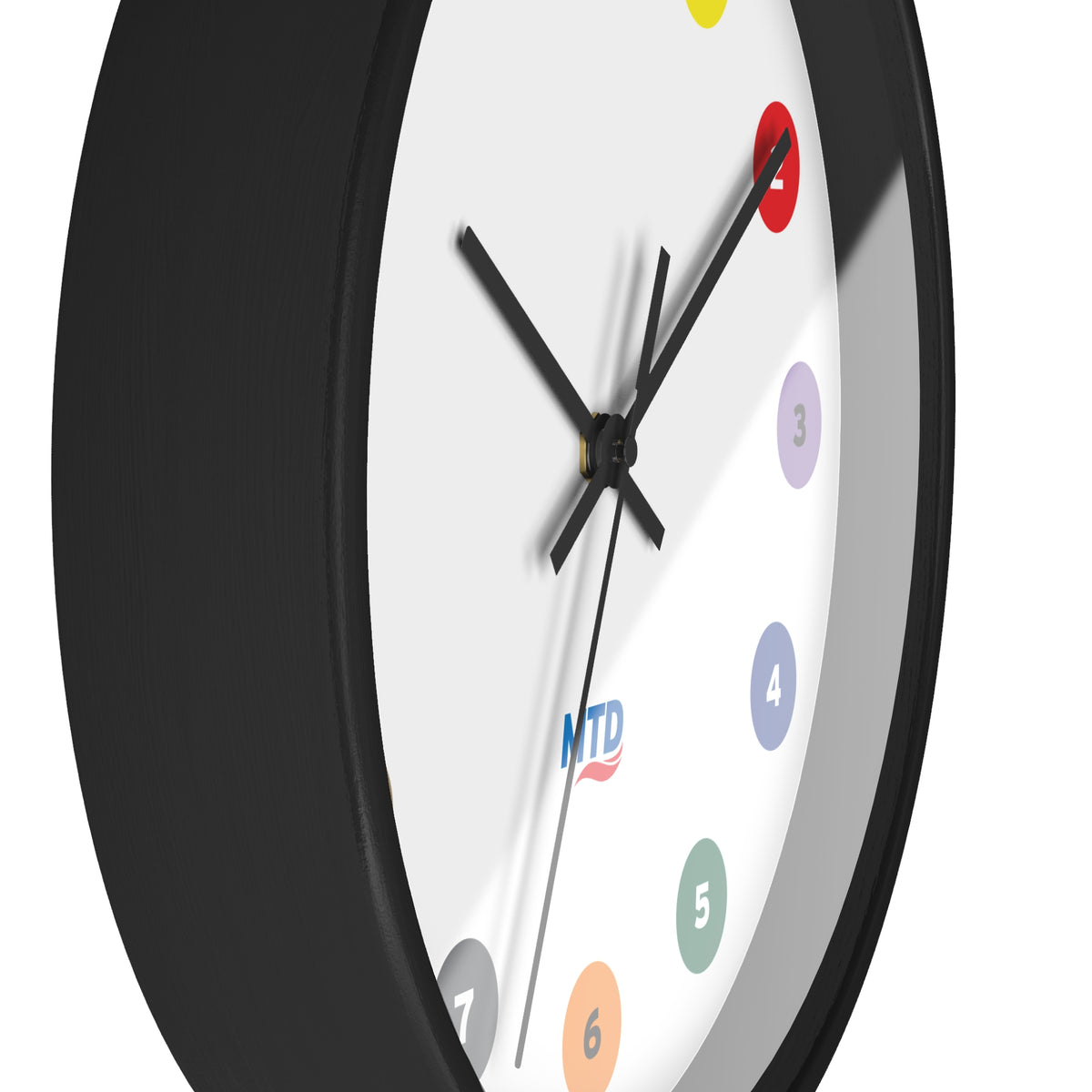 Primary Alt Text Round wall clock featuring colorful MTD route bubbles arranged as hour markers on a white clock face with the MTD logo in the center.