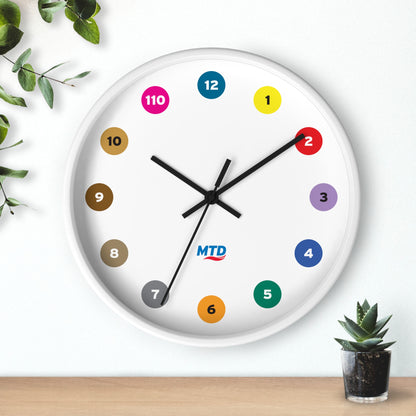Primary Alt Text Round wall clock featuring colorful MTD route bubbles arranged as hour markers on a white clock face with the MTD logo in the center.