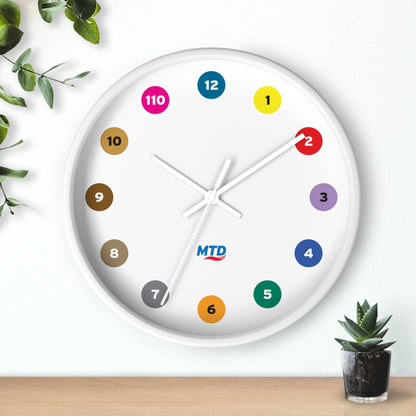Primary Alt Text Round wall clock featuring colorful MTD route bubbles arranged as hour markers on a white clock face with the MTD logo in the center.