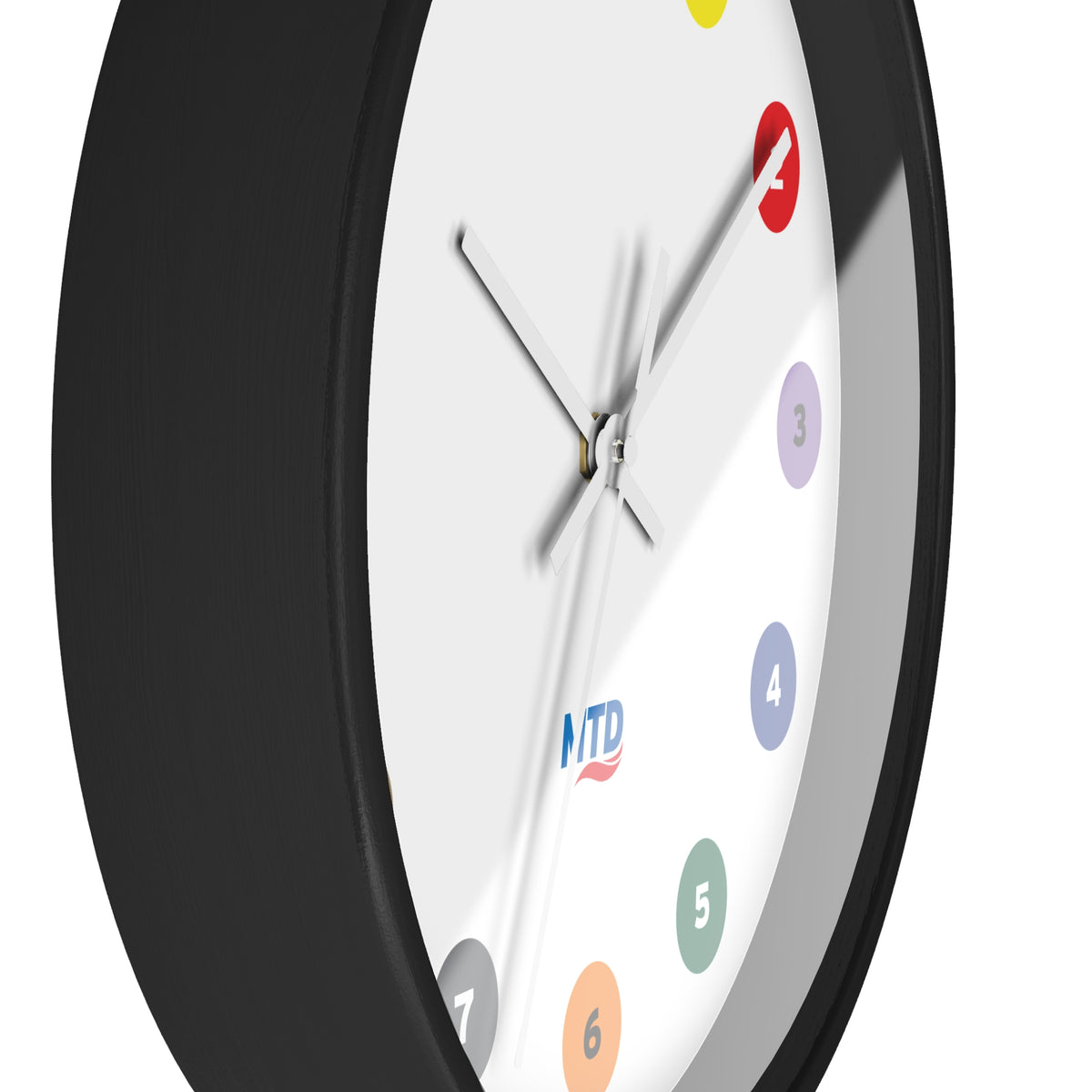 Primary Alt Text Round wall clock featuring colorful MTD route bubbles arranged as hour markers on a white clock face with the MTD logo in the center.