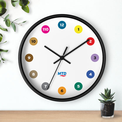 Primary Alt Text Round wall clock featuring colorful MTD route bubbles arranged as hour markers on a white clock face with the MTD logo in the center.