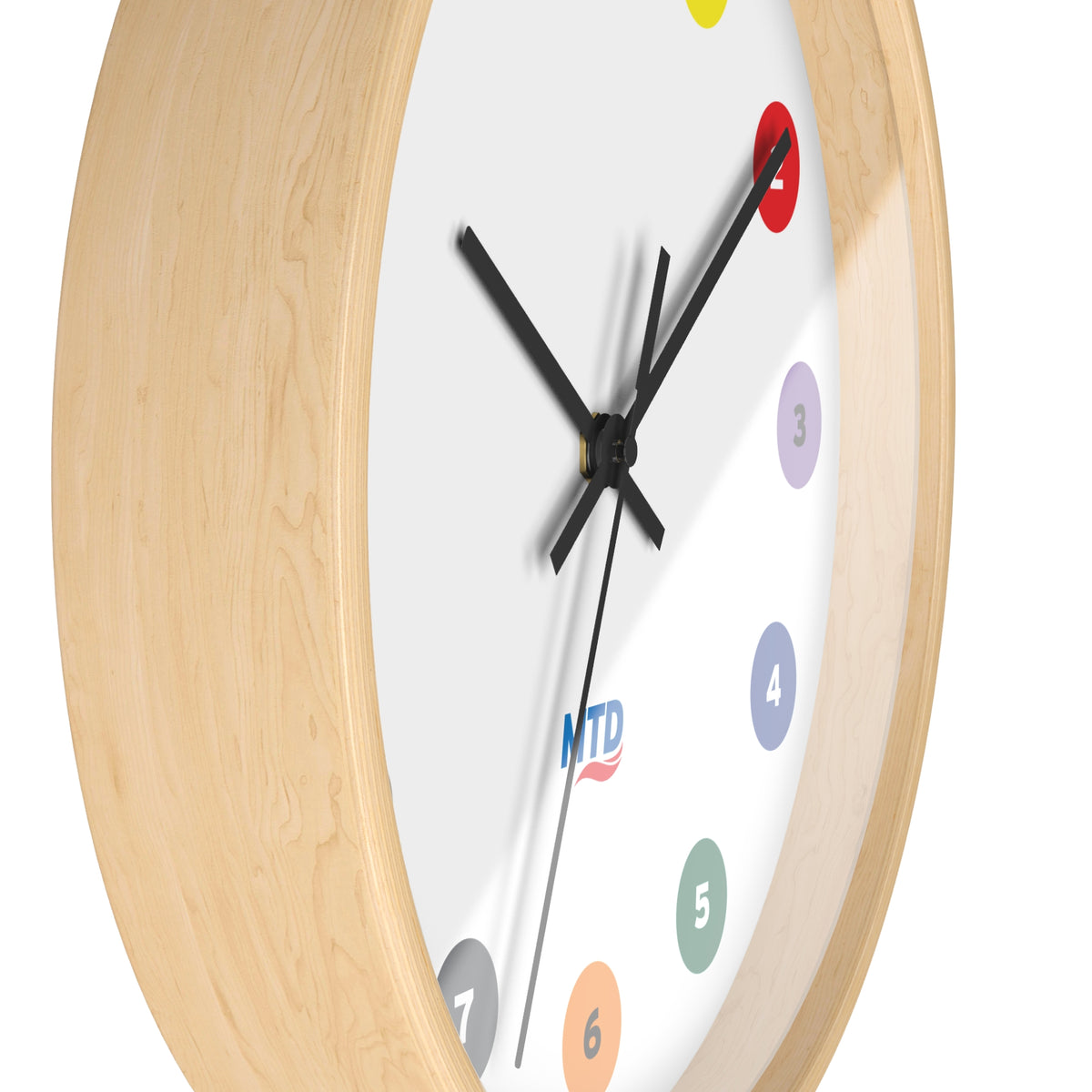 Primary Alt Text Round wall clock featuring colorful MTD route bubbles arranged as hour markers on a white clock face with the MTD logo in the center.