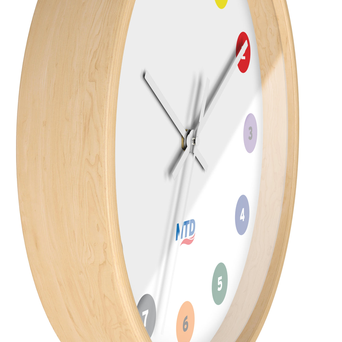 Primary Alt Text Round wall clock featuring colorful MTD route bubbles arranged as hour markers on a white clock face with the MTD logo in the center.