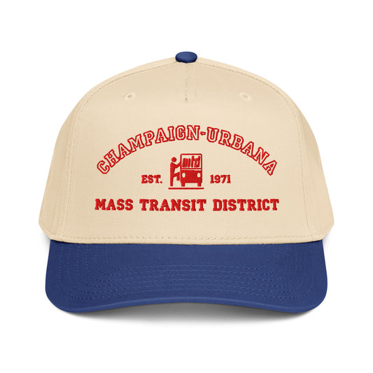 Front view of a tan snapback hat featuring a throwback MTD logo stitched in red with a blue visor.